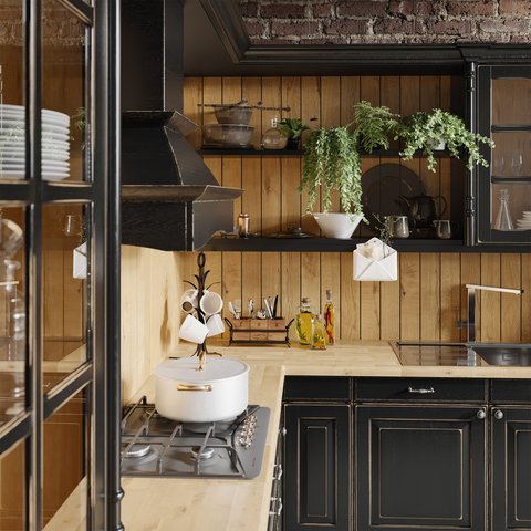 Seitliche Aufnahme einer modernen, schwarzen Landhausküche von Oster Seitliche Aufnahme einer modernen, schwarzen Landhausküche mit hölzernen und goldenen Akzenten von Oster